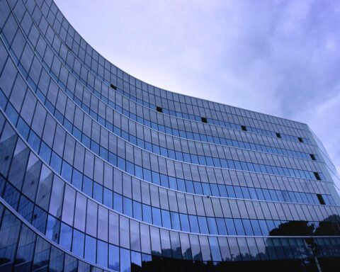 fish eye view photo of glass high story building over white cloudy sky during daytime