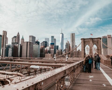 people standing on brown bridge