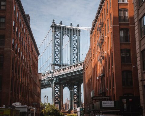 manhattan bridge seen between buildings