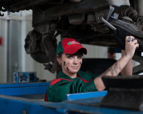 woman holding gray steel wrench