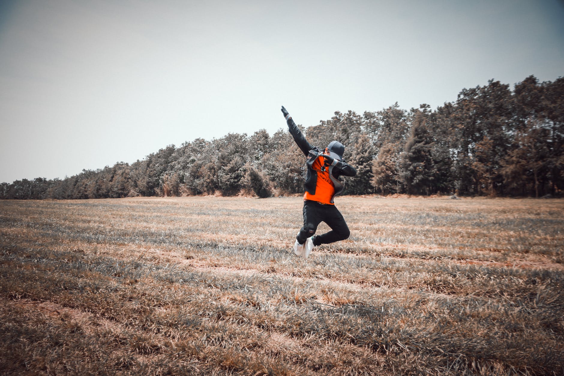 person jumping over grass