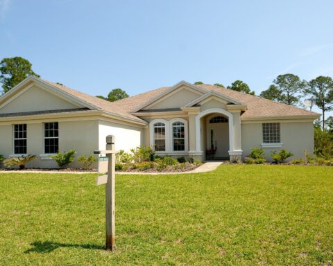 white and brown concrete bungalow under clear blue sky