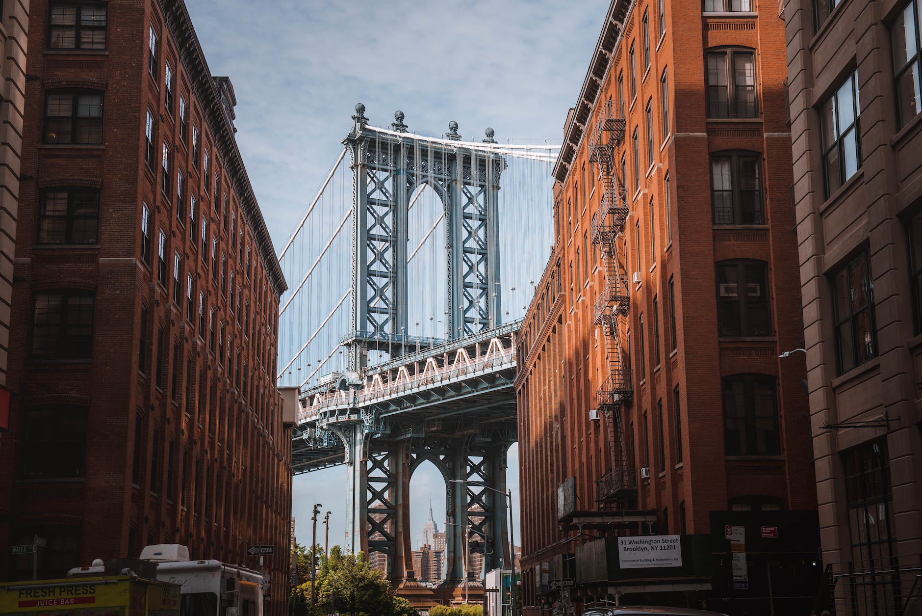 manhattan bridge seen between buildings