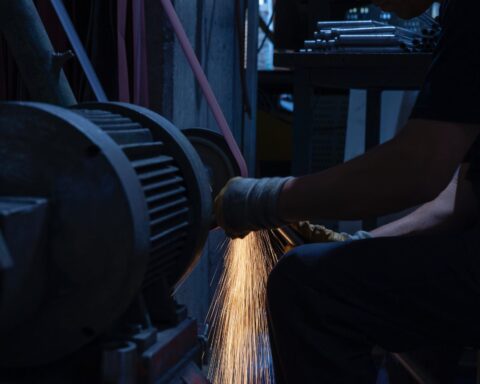 man grinding a metal