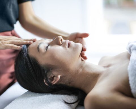 selective focus photo of woman getting a head massage