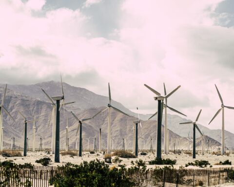 wind turbines under white cloudy sky