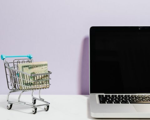 shopping cart next to a laptop