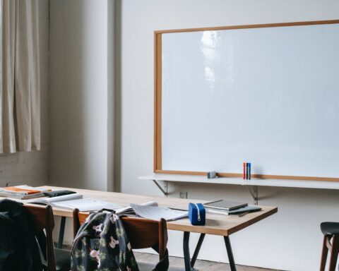 school bench with stationery in classroom