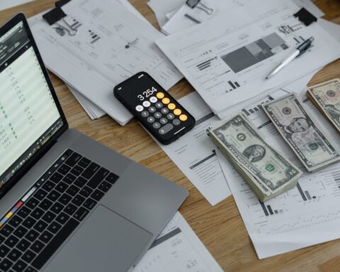 banknotes and calculator on table