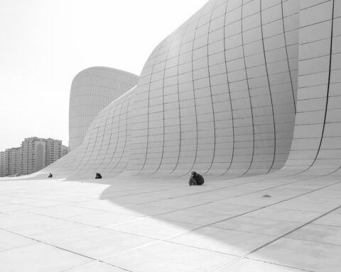 people sitting by walls of heydar aliyev center