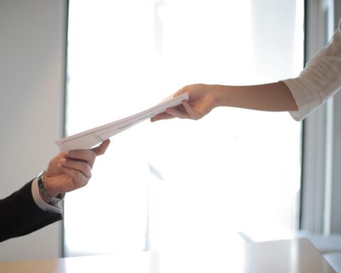 job applicant passing her documents