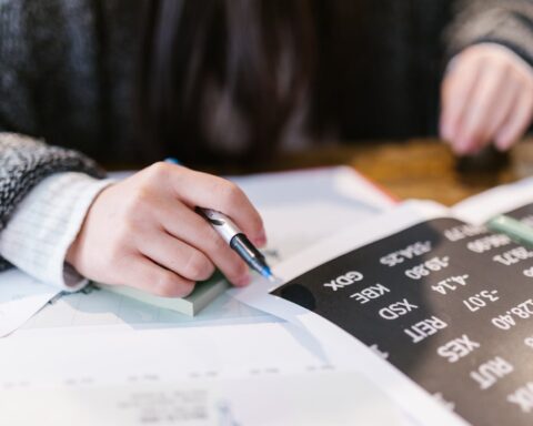 person writing on white paper